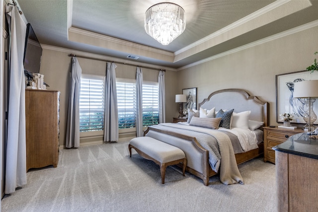 bedroom featuring ornamental molding, a tray ceiling, an inviting chandelier, and light colored carpet