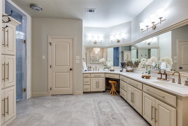 bathroom with tile patterned floors, a textured ceiling, a shower, and vanity