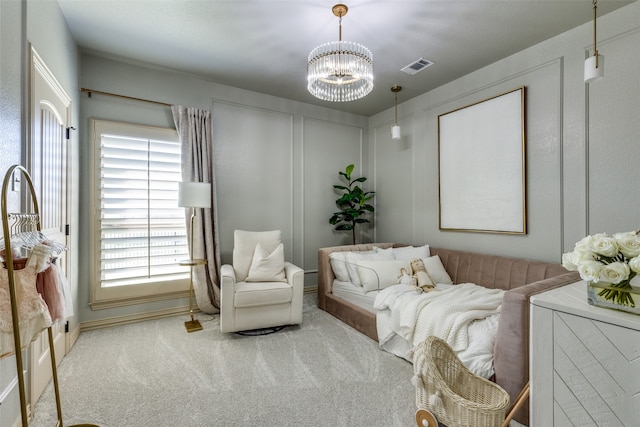 carpeted bedroom with an inviting chandelier