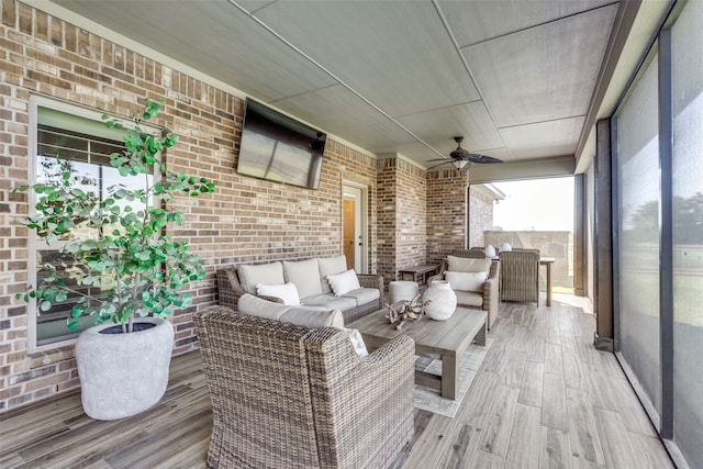 unfurnished sunroom featuring ceiling fan and plenty of natural light