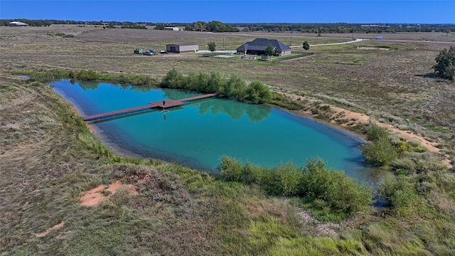 drone / aerial view featuring a rural view and a water view