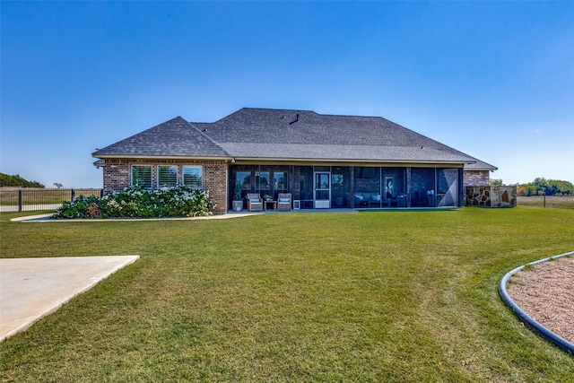 rear view of property with a lawn and a patio area