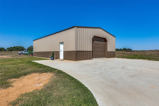 view of outbuilding with a yard and a garage