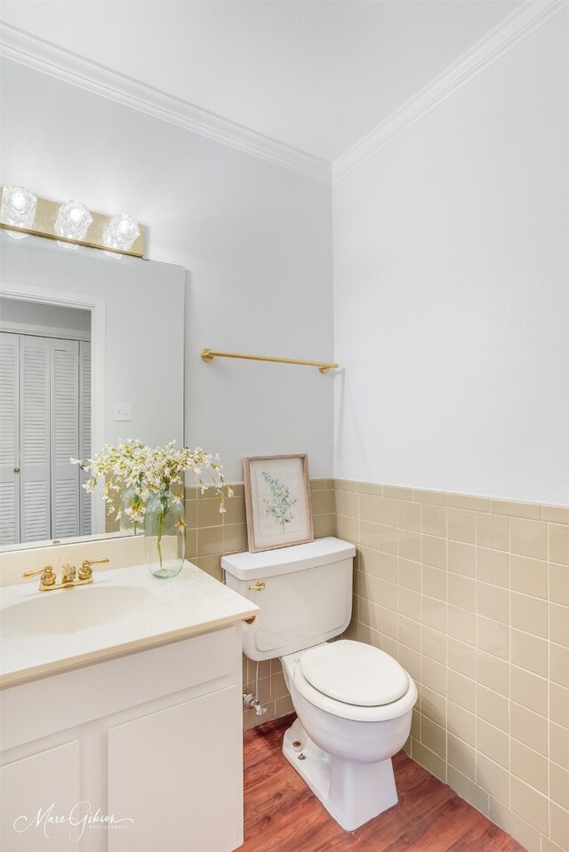 bathroom featuring tile walls, vanity, toilet, and hardwood / wood-style flooring