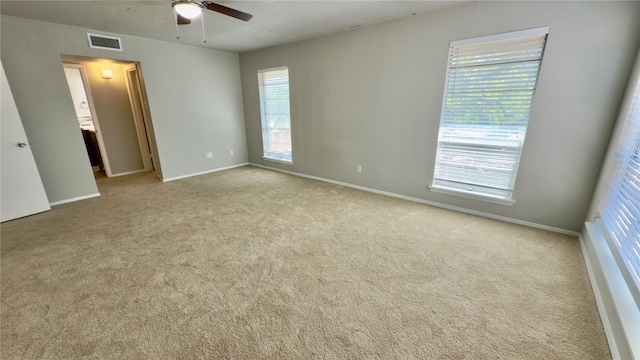 unfurnished room with ceiling fan and light colored carpet