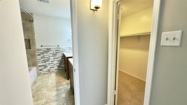 bathroom featuring vanity, tile walls, separate shower and tub, and tile patterned floors