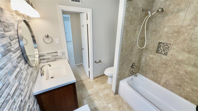 full bathroom with tile patterned flooring, vanity, toilet, and tiled shower / bath