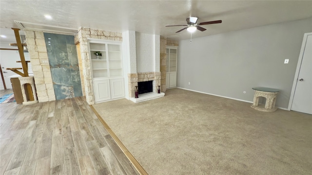 unfurnished living room with a fireplace, hardwood / wood-style floors, and ceiling fan