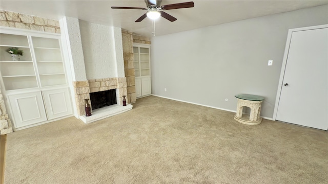 unfurnished living room with carpet, ceiling fan, and a fireplace