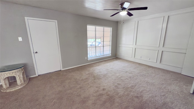 interior space with ceiling fan and light colored carpet