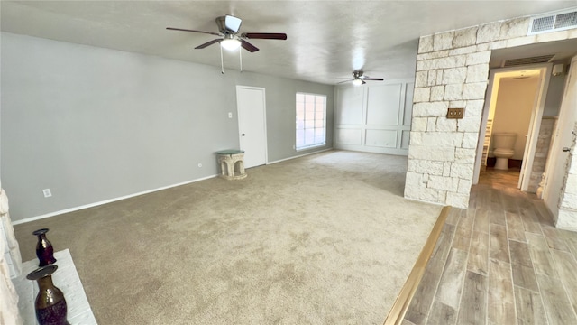 unfurnished living room with wood-type flooring and ceiling fan