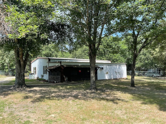 view of outbuilding featuring a yard