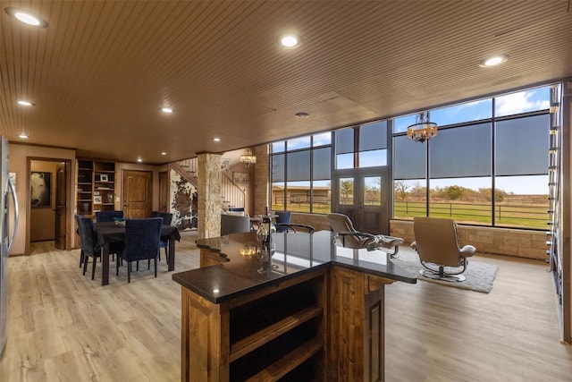 interior space featuring wood ceiling, an inviting chandelier, and a wealth of natural light