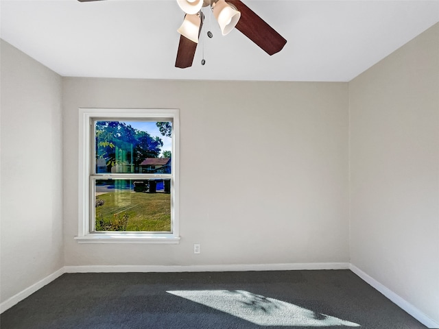 empty room with dark carpet and ceiling fan