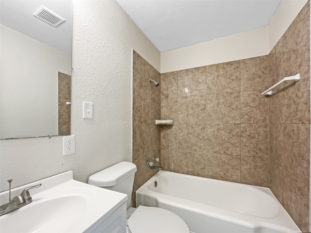 full bathroom featuring vanity, tiled shower / bath combo, and toilet