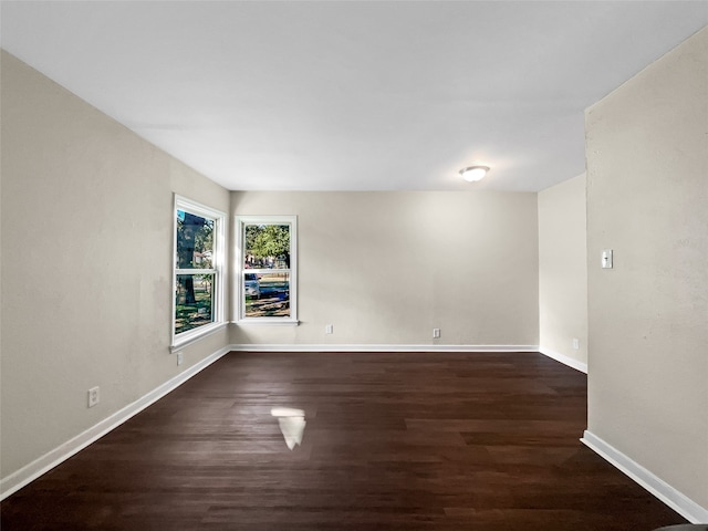 unfurnished room with dark hardwood / wood-style floors