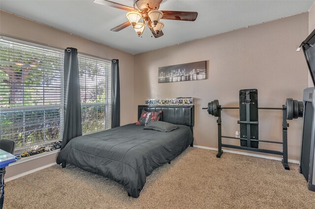 bedroom with ceiling fan and light colored carpet