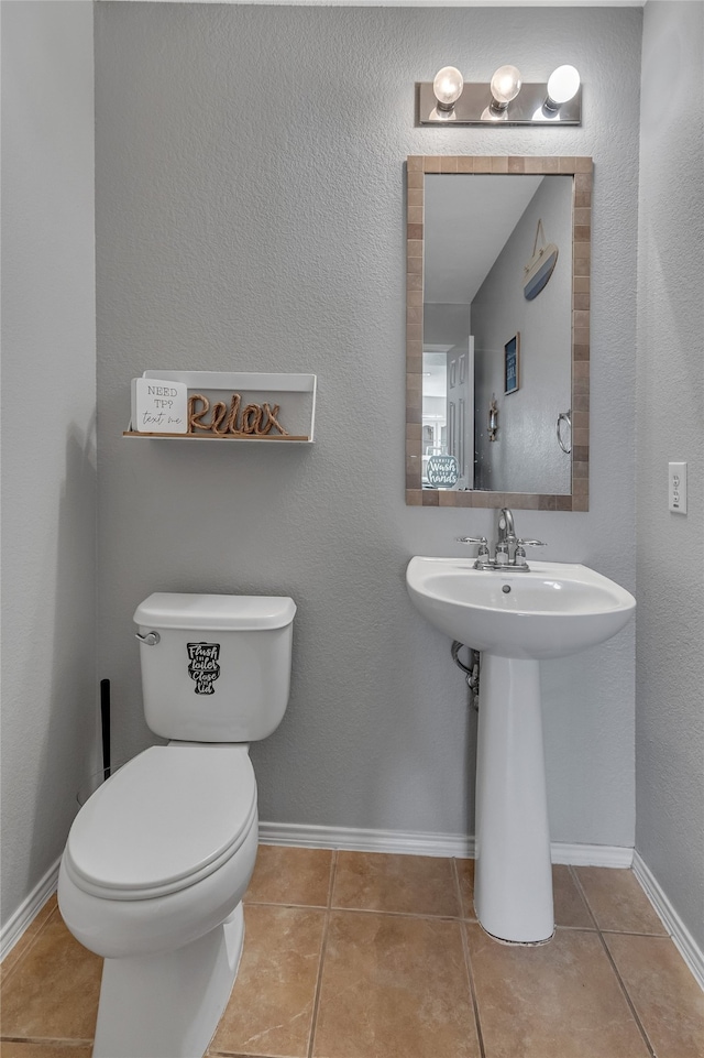 6001 Red Drum Dr, Fort Worth, TX 76179 - bathroom with toilet, tile patterned floors, and baseboards