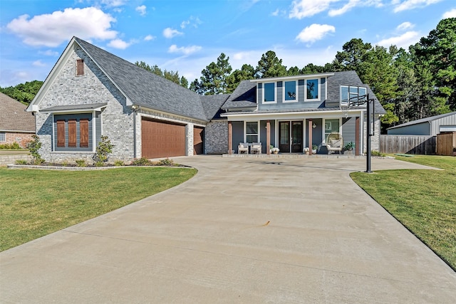 view of front of property featuring a front yard and a garage