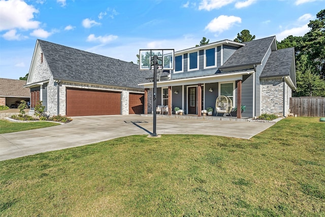 view of front facade featuring a porch, a garage, and a front yard