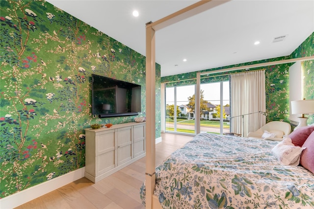 bedroom with access to exterior and light hardwood / wood-style floors