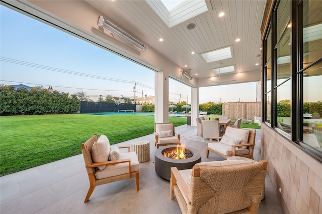 view of patio / terrace with an outdoor living space with a fire pit