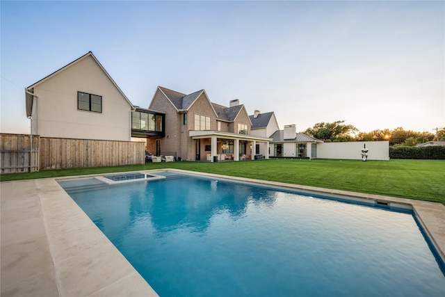 view of swimming pool with a yard