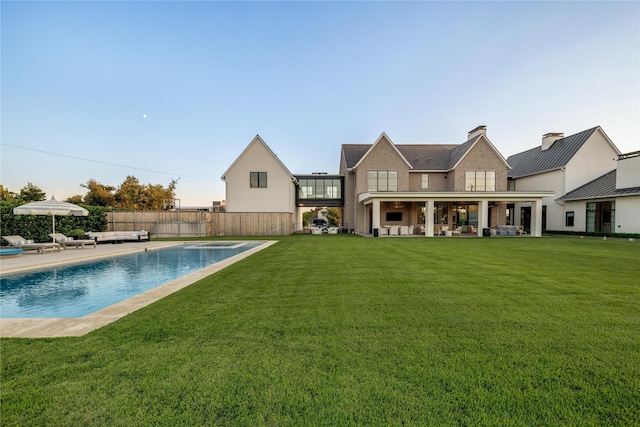 view of swimming pool featuring a lawn, a patio area, and an outdoor hangout area