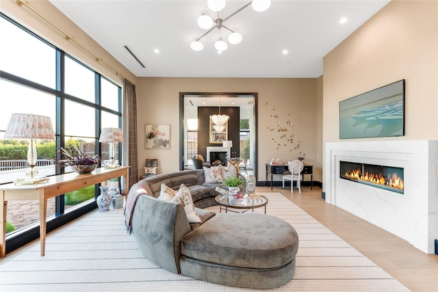 living room featuring a chandelier and light hardwood / wood-style flooring