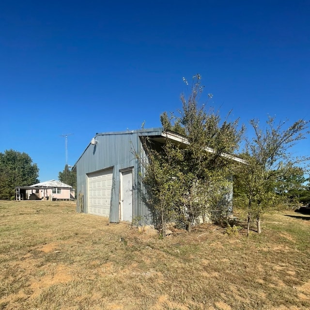 view of outdoor structure featuring a lawn