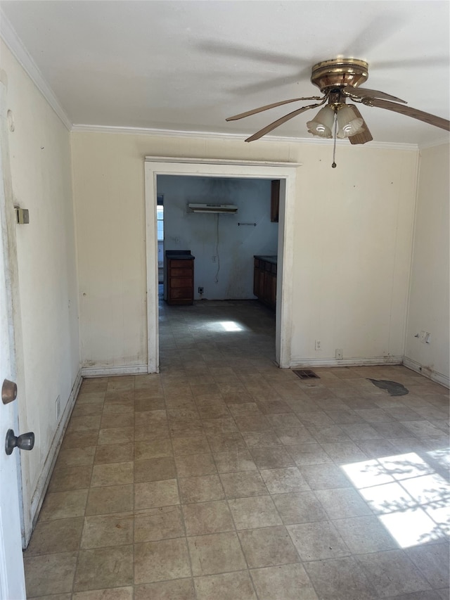 empty room featuring ceiling fan and ornamental molding