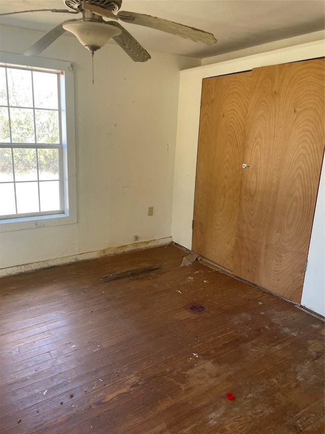 unfurnished bedroom featuring ceiling fan and dark hardwood / wood-style floors