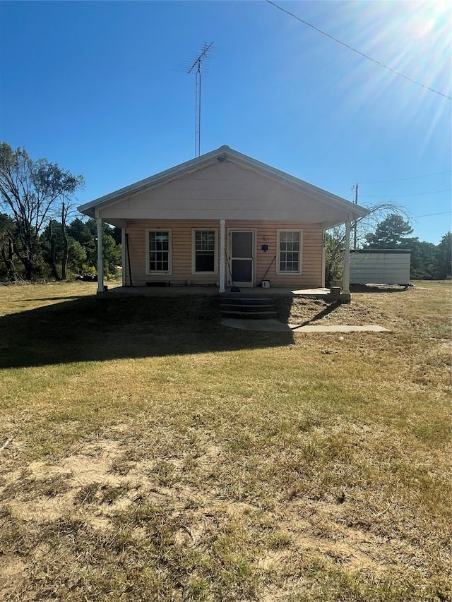 back of property with a lawn