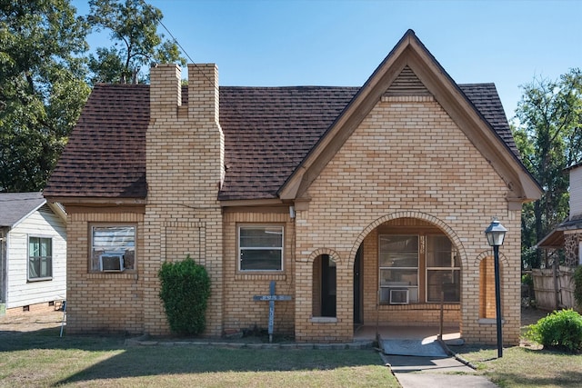 view of front of property with cooling unit and a front yard