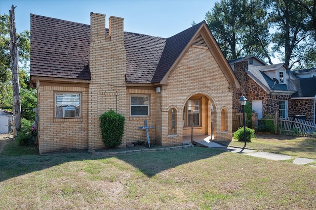 tudor home featuring a front yard