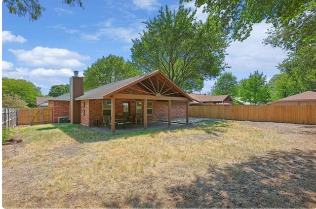 rear view of house featuring cooling unit and a patio