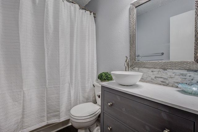 bathroom with vanity, toilet, and walk in shower