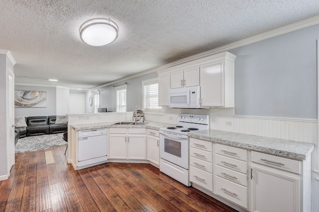 kitchen with sink, dark wood-type flooring, white cabinets, and white appliances