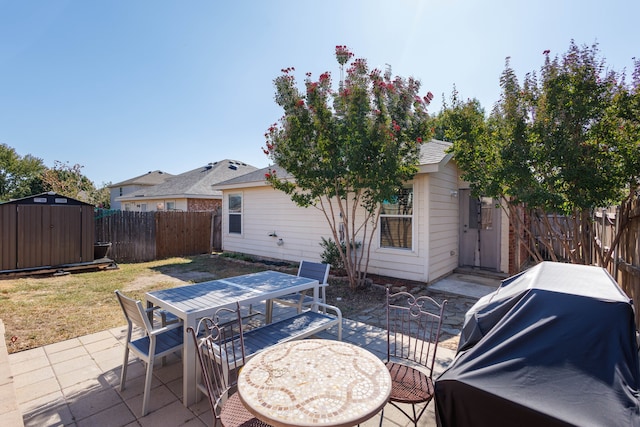 view of patio featuring a storage unit and area for grilling