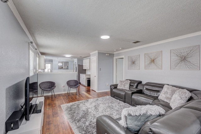 living room featuring crown molding, a textured ceiling, and hardwood / wood-style floors