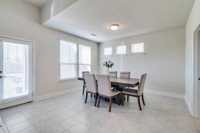 tiled dining space with a wealth of natural light