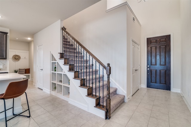 foyer entrance with light tile patterned floors