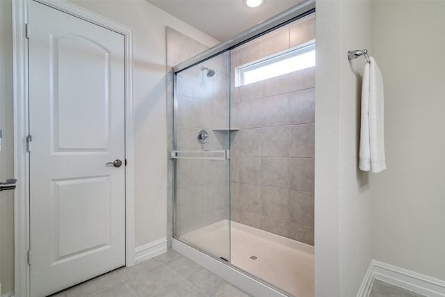 bathroom featuring tile patterned flooring and an enclosed shower