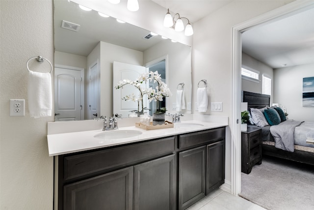 bathroom with tile patterned flooring and vanity