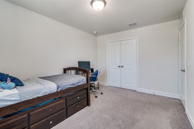 bedroom with light carpet and a closet