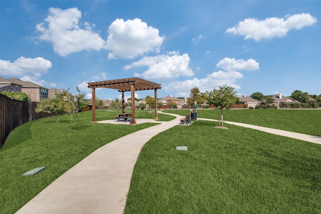 view of community featuring a pergola and a lawn