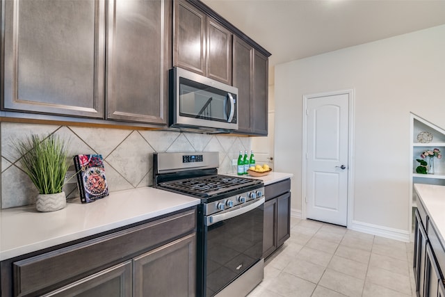 kitchen with dark brown cabinets, backsplash, stainless steel appliances, and light tile patterned flooring