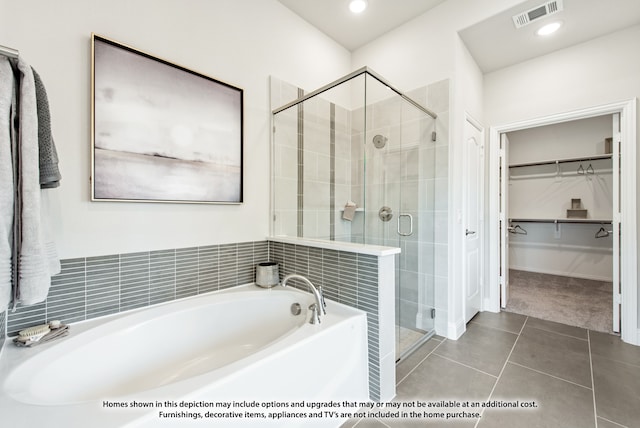 bathroom featuring independent shower and bath and tile patterned flooring