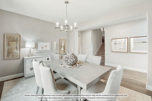 dining space featuring light hardwood / wood-style flooring and a notable chandelier