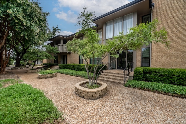 rear view of property featuring a balcony